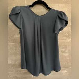 Dusty blue top with petal sleeve.